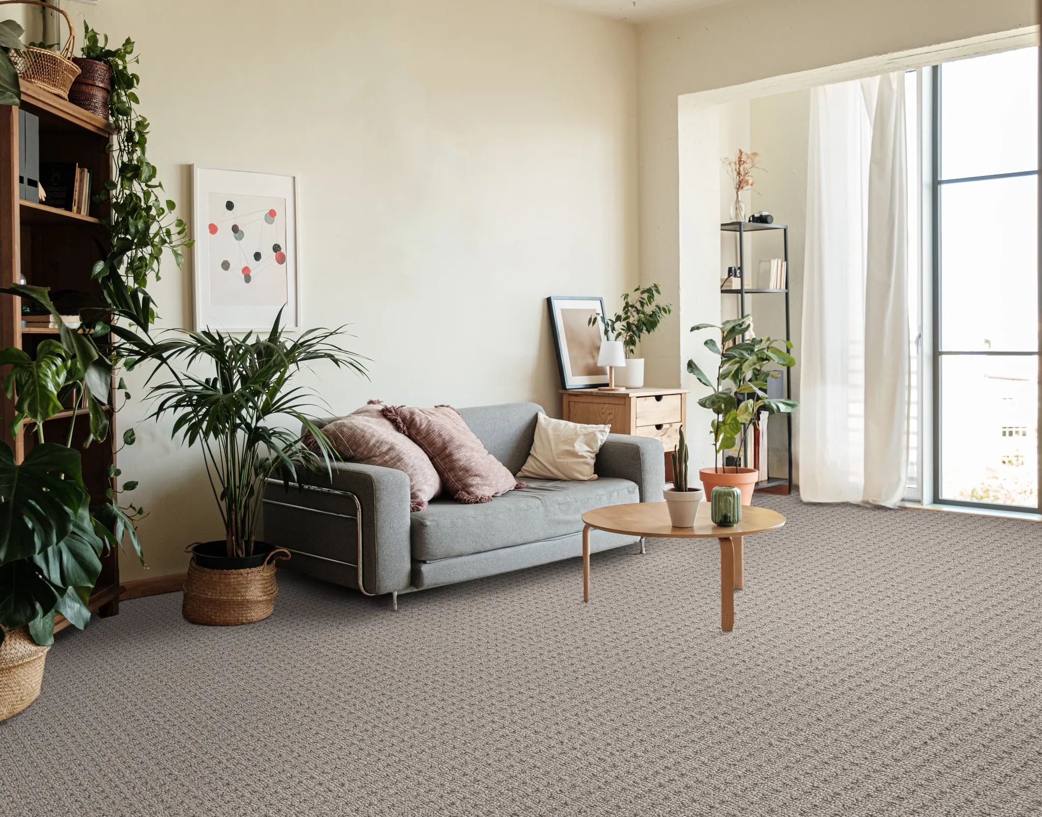 Modern living room with gray sofa, wooden coffee table, and indoor plants on textured soft surface flooring