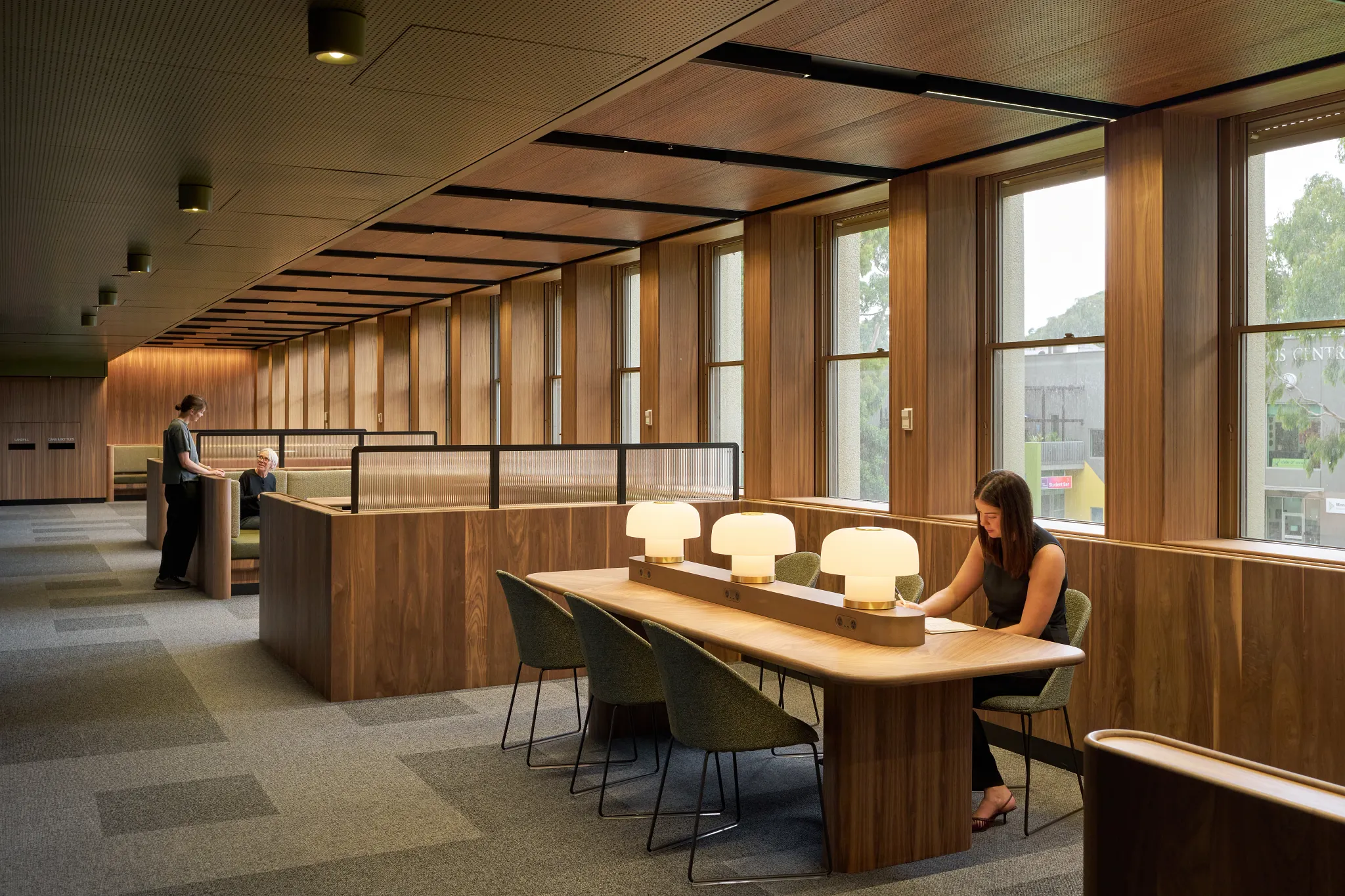 Study and collaboration area within the Monash University Clayton Menzies Building Level 1 Teaching Space Upgrades project by Hayball, featuring timber finishes, integrated booth seating and flexible learning spaces.