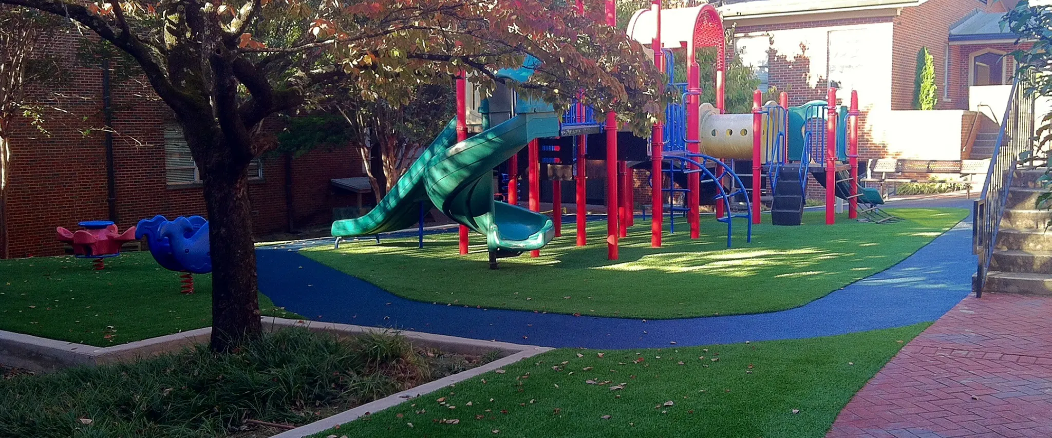Playground with colorful equipment and artificial grass