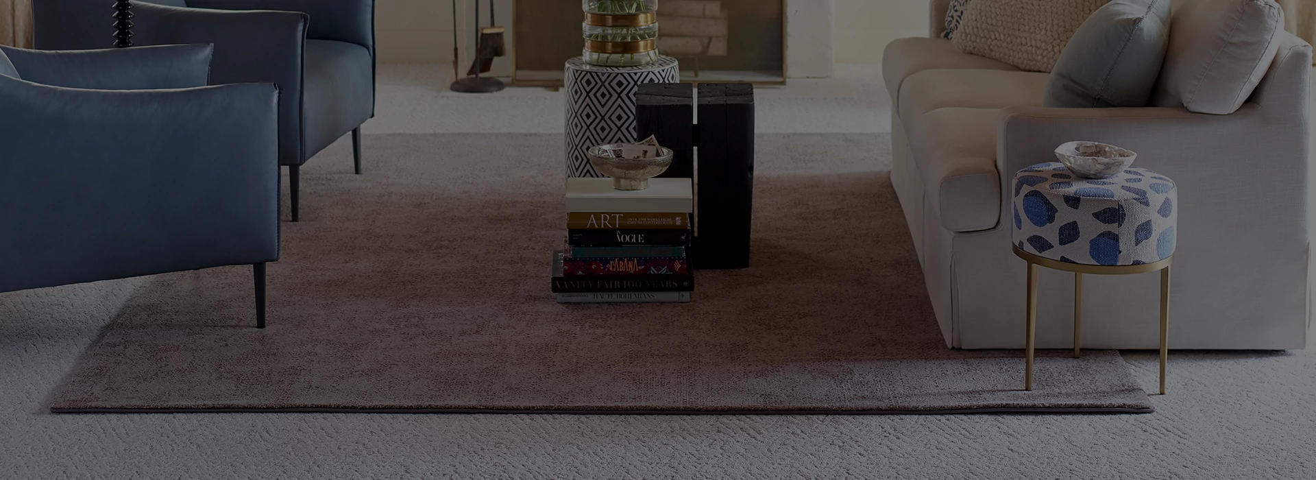 living room with layered rug on carpet with upscale furniture