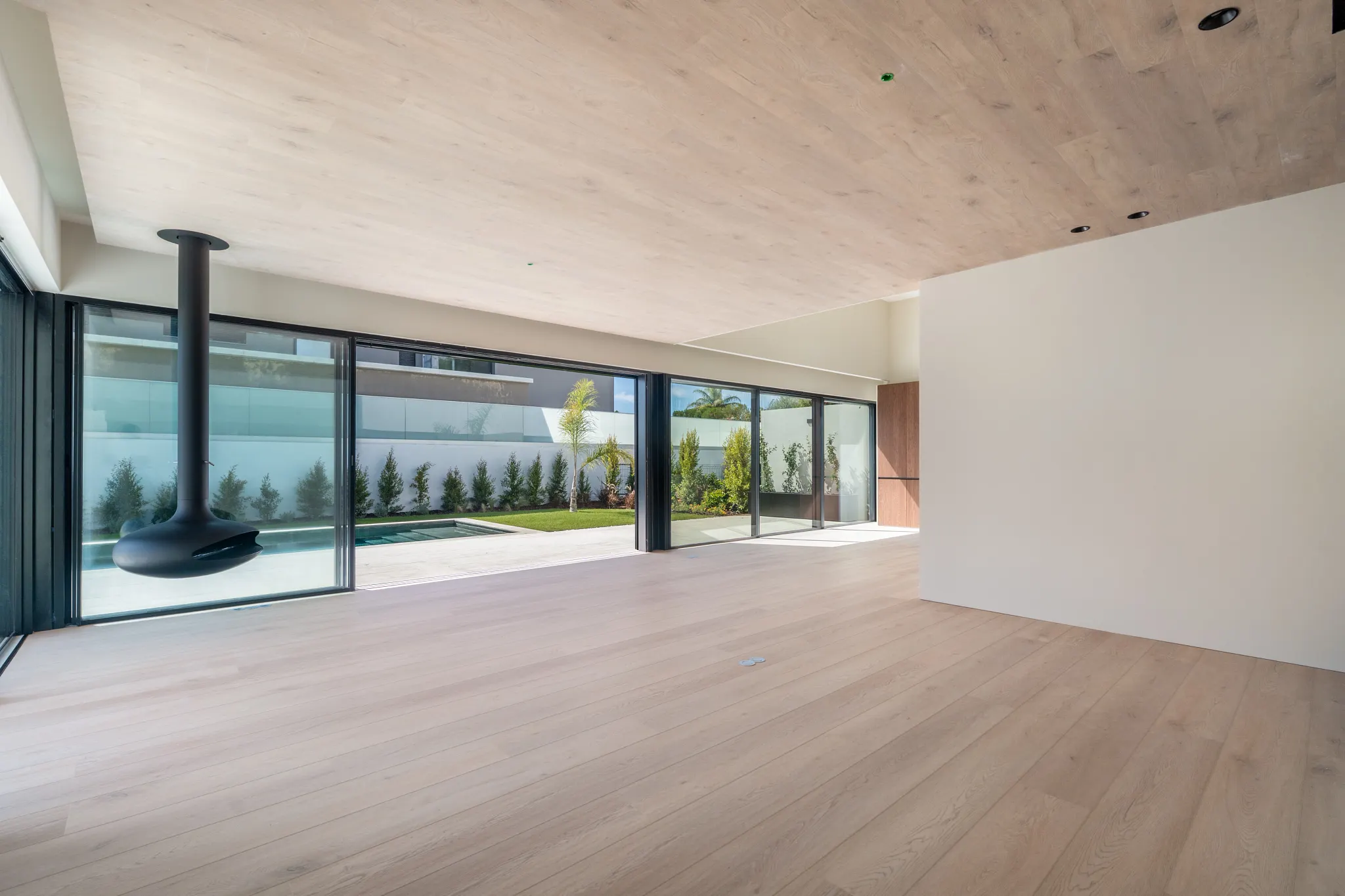 Modern living room with wooden floor and ceiling from Coretec