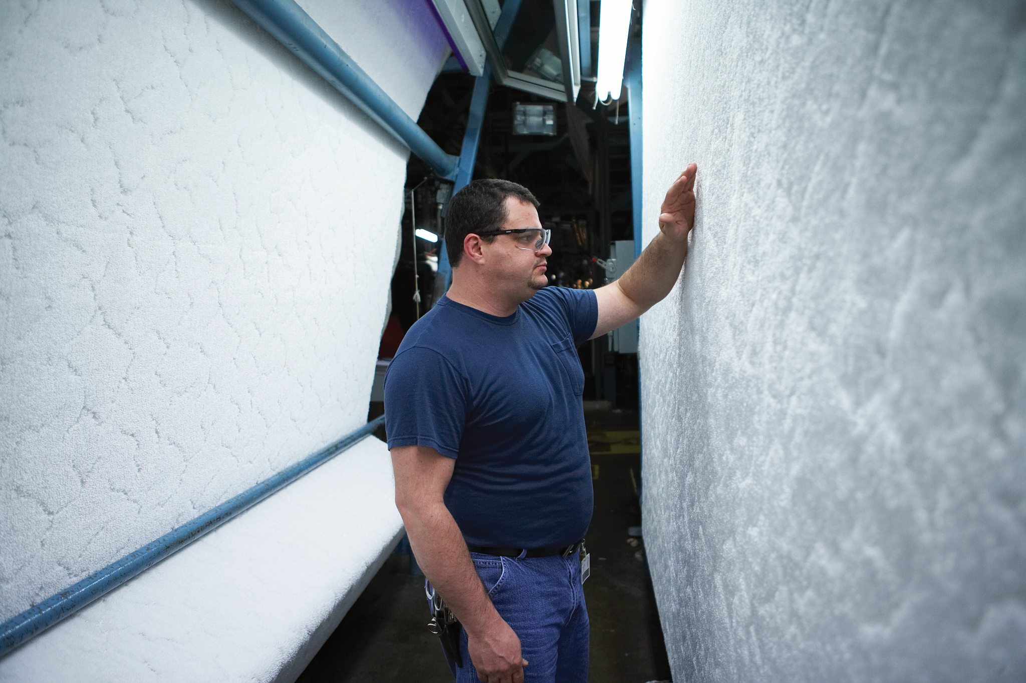 Man inspecting carpet on a manufacturing line