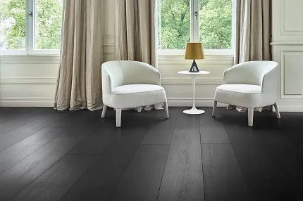 Dark Wood Look Luxury Vinyl Plank Flooring in Modern Living Room Modern living room with dark wood look luxury vinyl plank flooring and two white armchairs