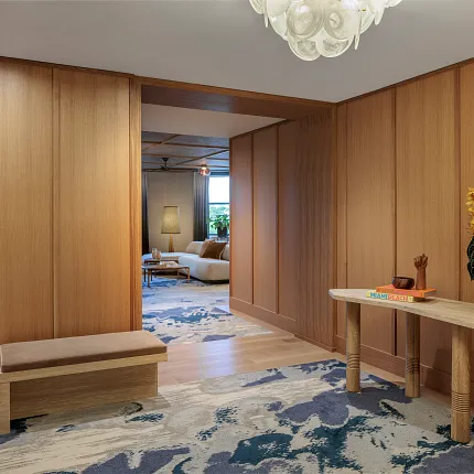 Contemporary interior with stylish carpet and wood accents Modern hallway with abstract carpet design and wooden paneling