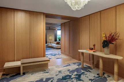 Contemporary interior with stylish carpet and wood accents Modern hallway with abstract carpet design and wooden paneling