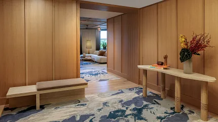 Contemporary interior with stylish carpet and wood accents Modern hallway with abstract carpet design and wooden paneling