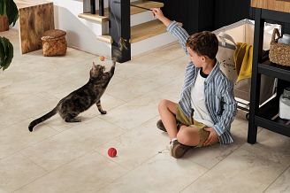 A child plays with a cat on a Coretec tile floor