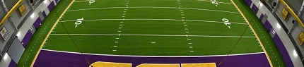 Artificial Turf Indoor Football Field with LSU Branding Indoor football field with artificial turf featuring LSU logo and purple end zones