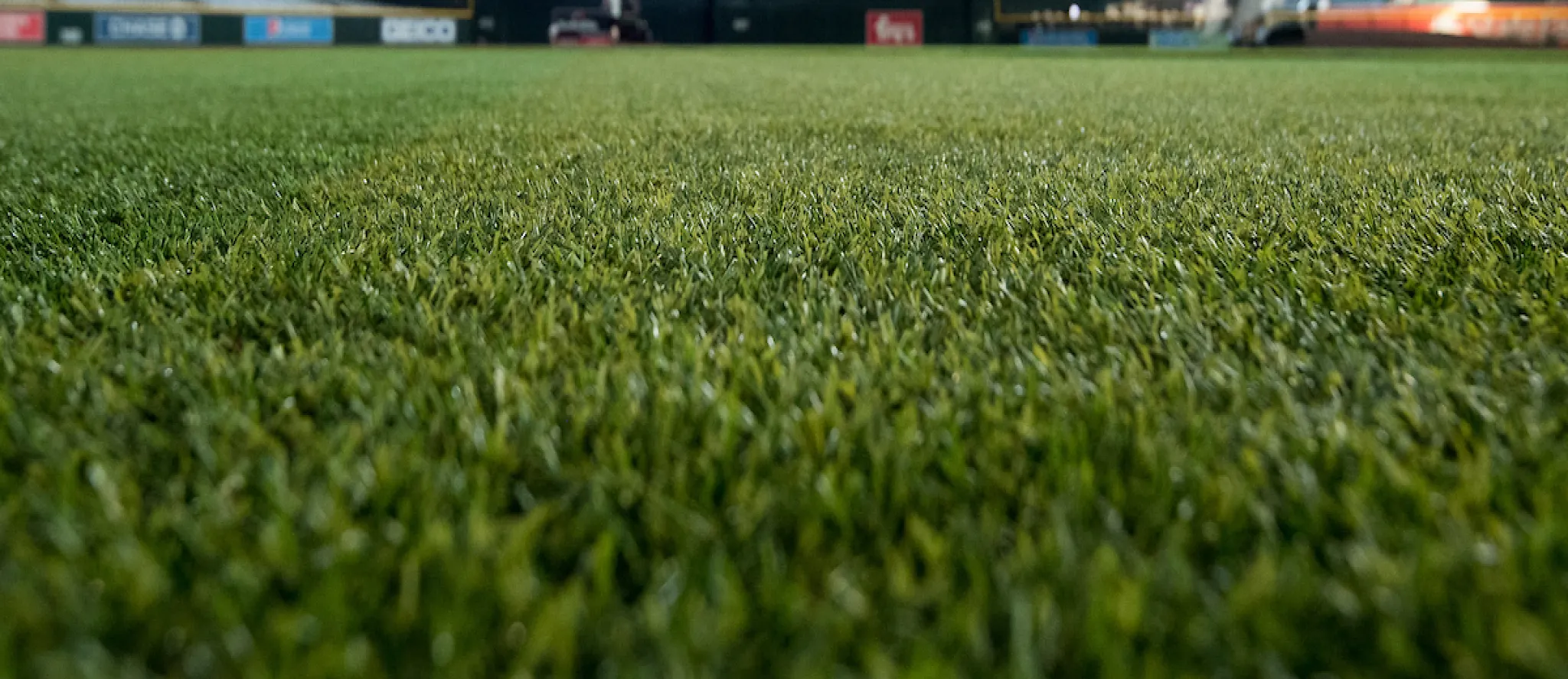 Athletes competing on vibrant Shaw Sports Turf field showcasing high-performance synthetic turf system.
