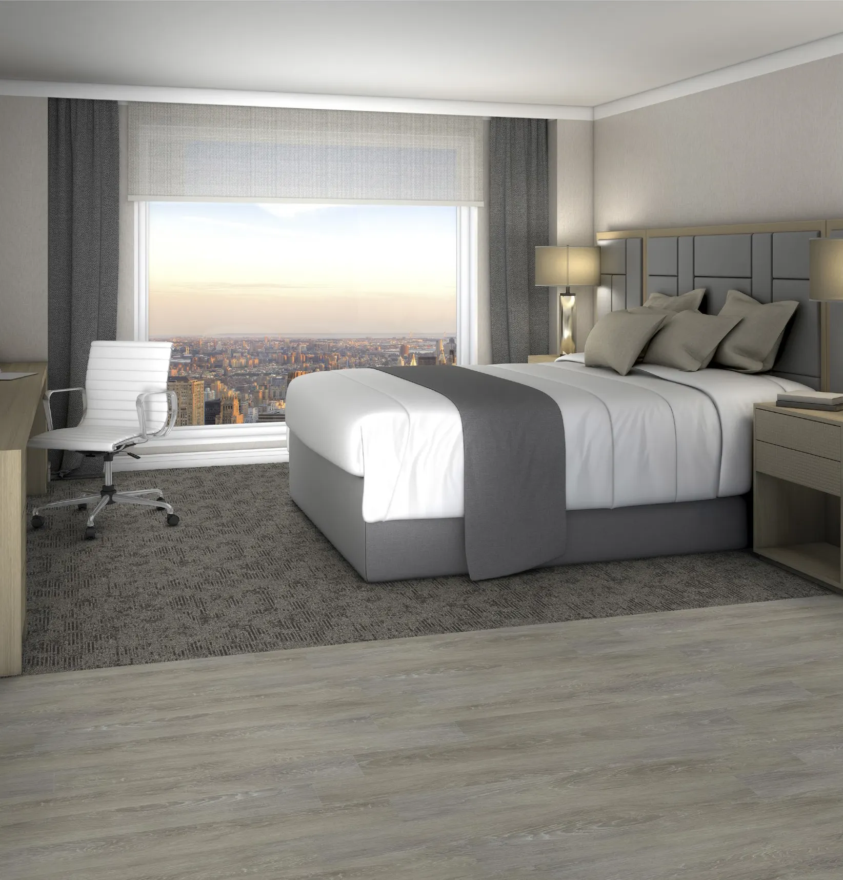 Modern hotel room with a large bed, white and gray bedding, gray carpet, and light wood flooring