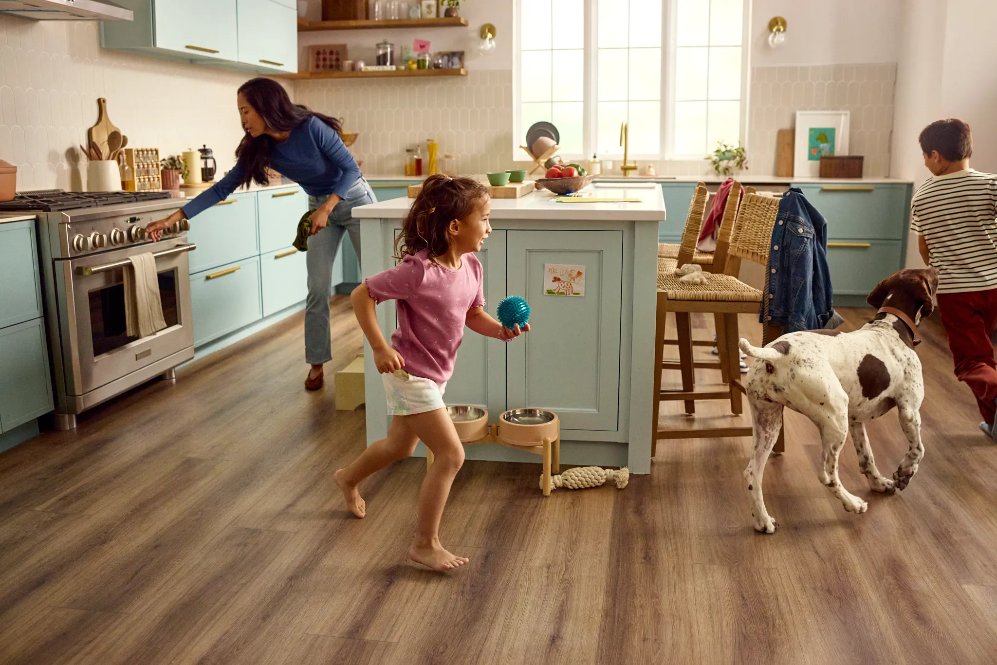 Family kitchen with durable hardwood flooring and playful children