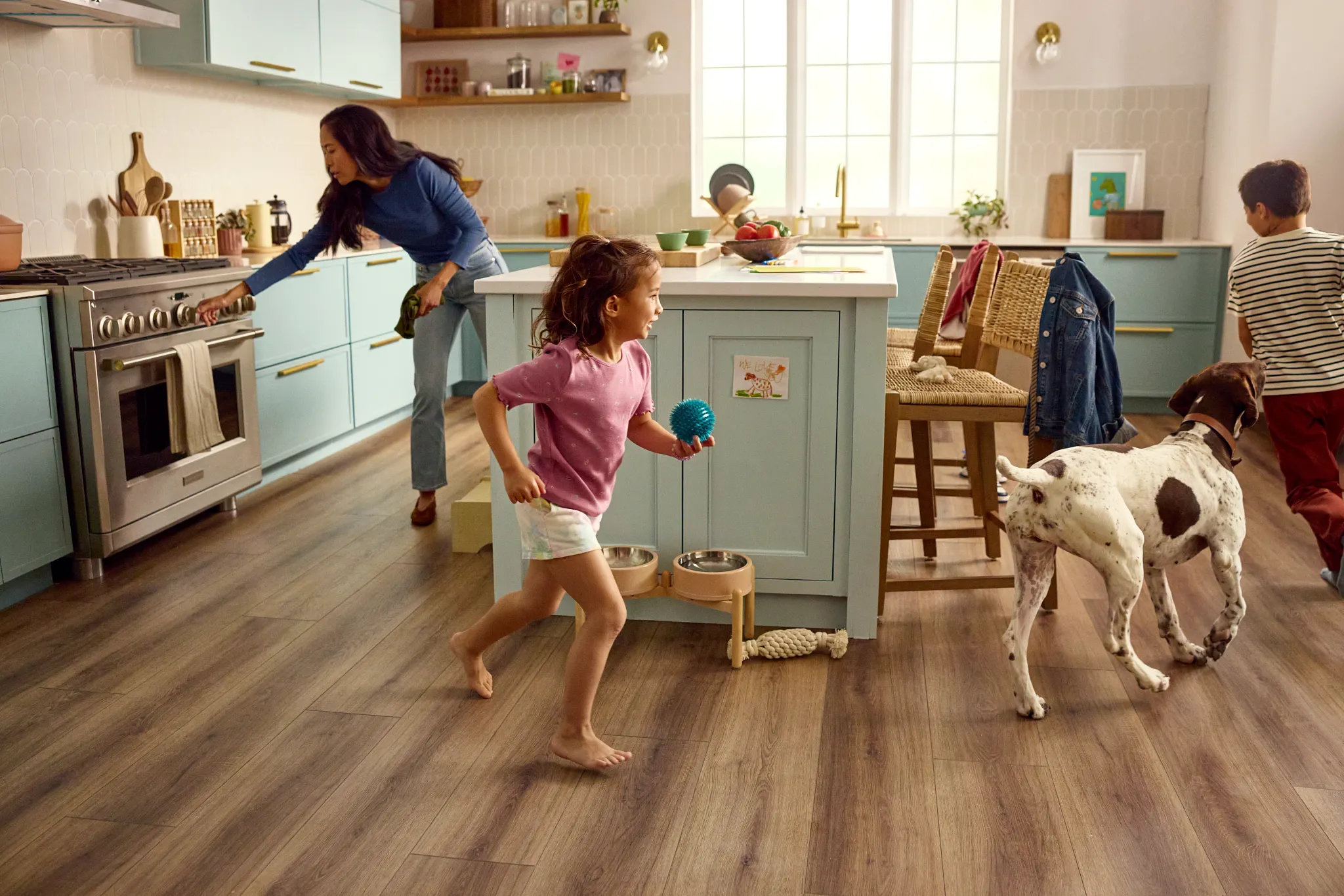 A golden retriever walks into a brightly lit room on a leash, trotting on Pet Perfect carpet from Shaw Floors. The image includes a graphic that reads "Preferred Flooring of American Kennel Club"