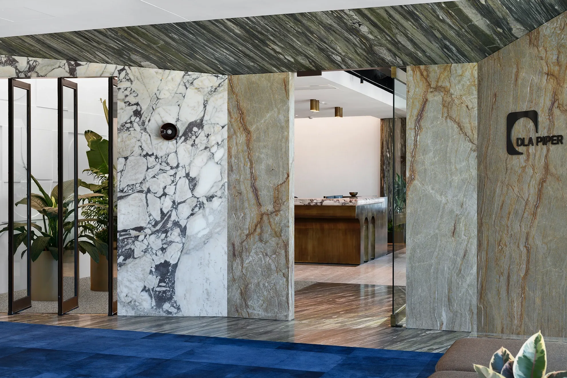 Modern office lobby with blue carpet and marble walls