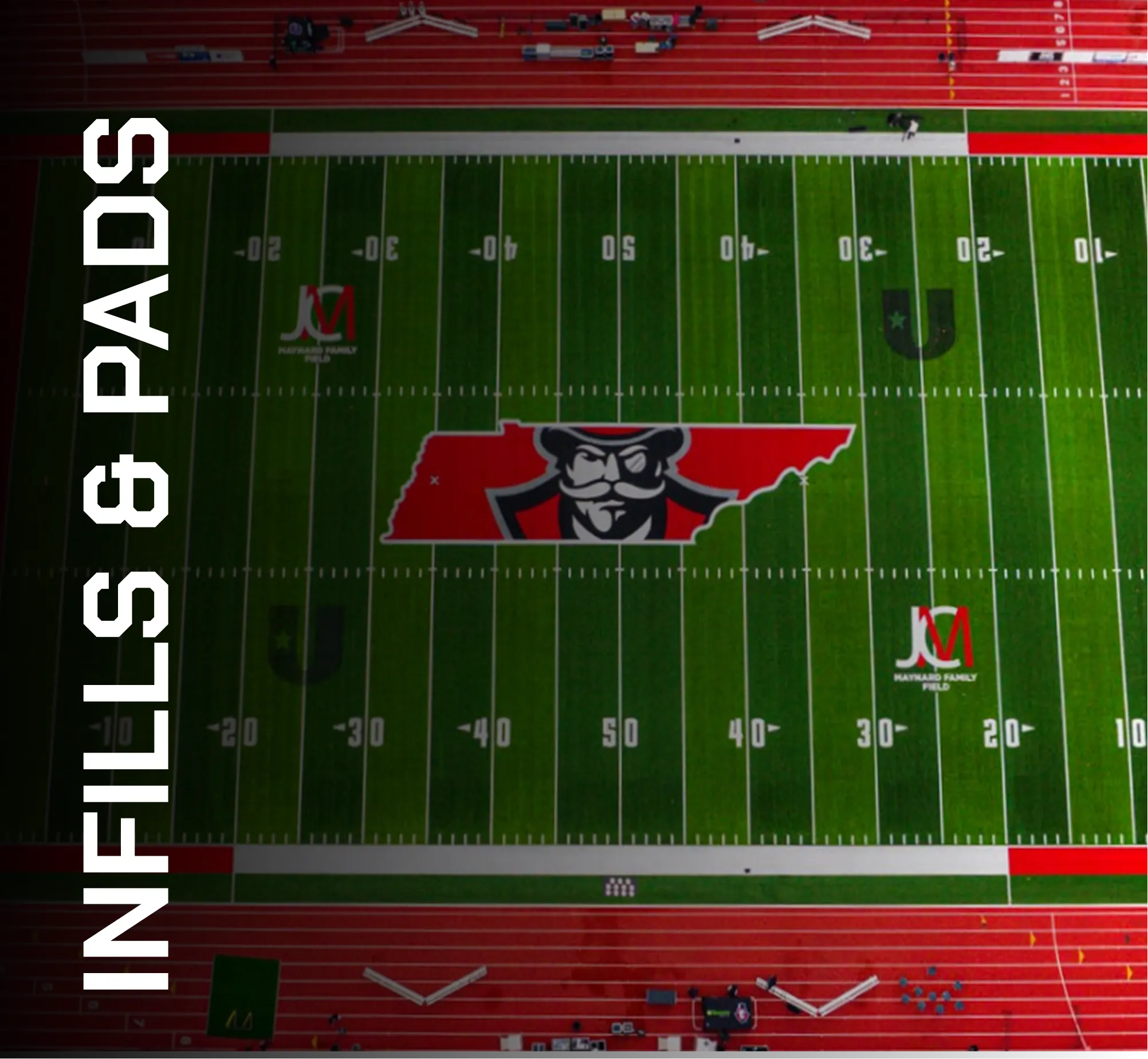 Aerial view of artificial turf football field with red and green markings