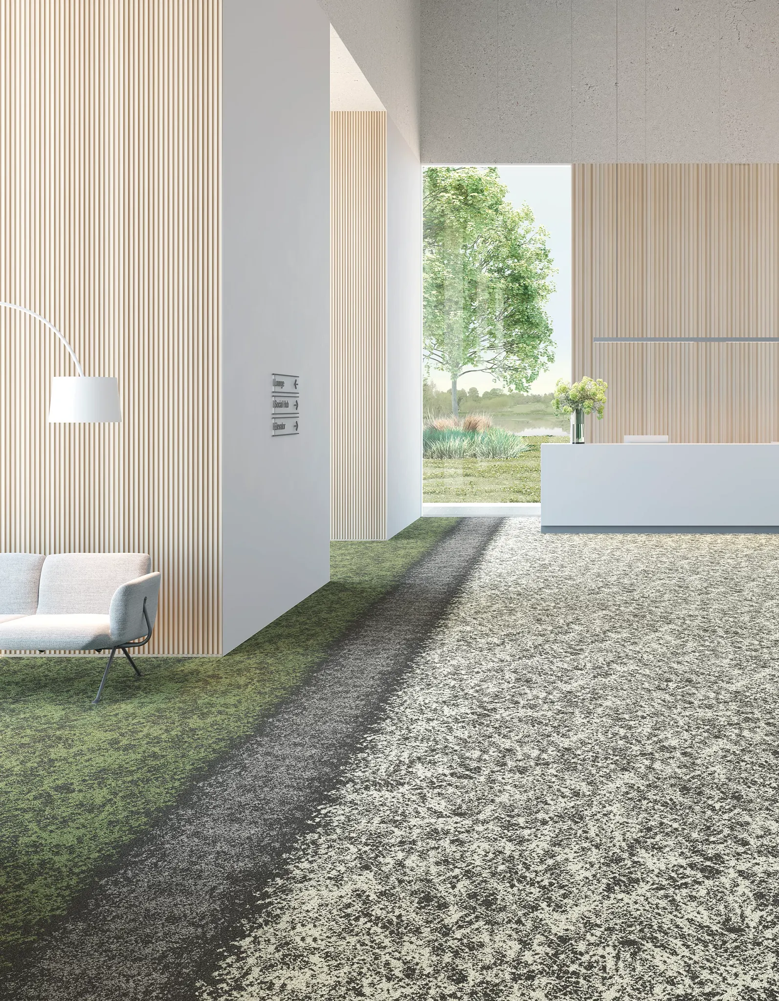 Modern reception area with green and gray commercial carpet tile flooring, featuring a sleek white reception desk and a large window with a view of greenery