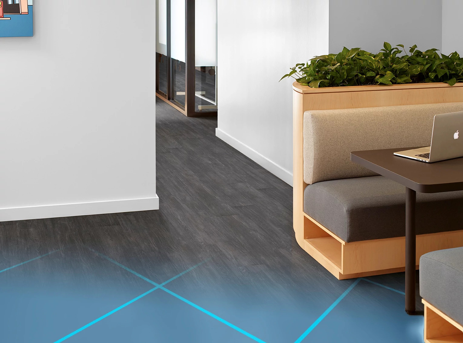 
  "Modern office space with dark wood-look flooring and contemporary furniture"
)