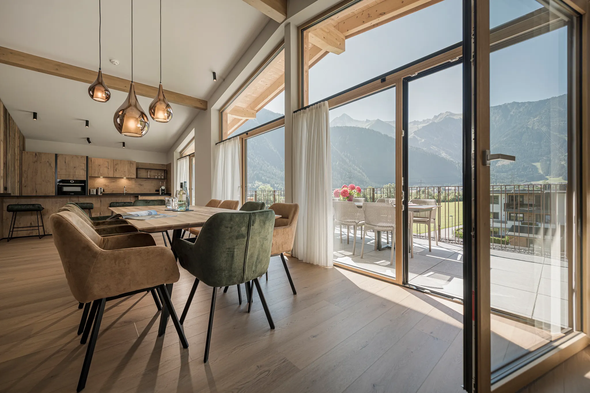 Dining room with premium oak flooring with view on mountains 