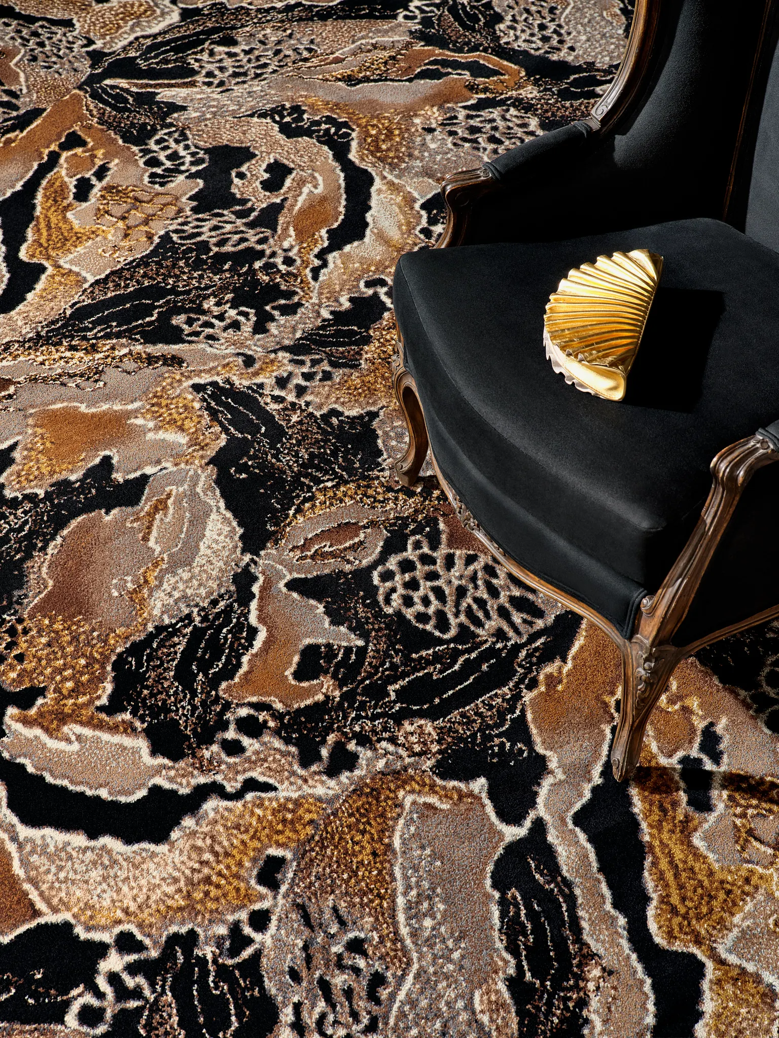 Abstract patterned carpet in black, brown, and beige with elegant chair