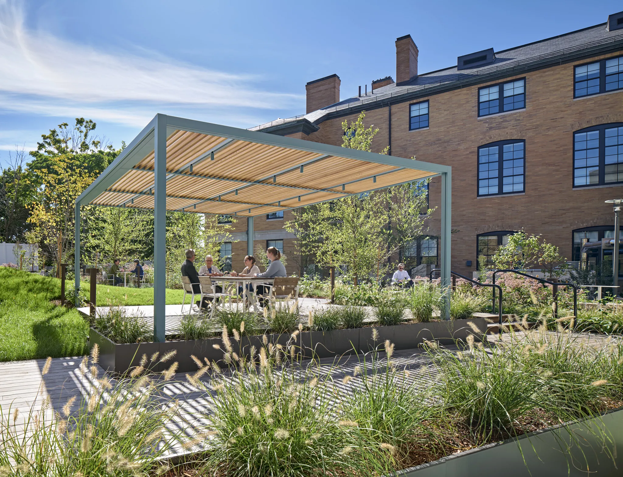 Outdoor seating area with pergola and greenery