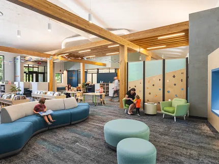 Education Facility with Commercial Carpet Tile Flooring in Library Setting Modern education facility with children and adults in a library setting featuring commercial carpet tile flooring in shades of gray and blue