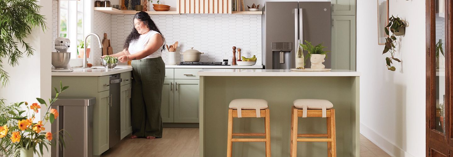 woman standing at kitchen counter preparing food