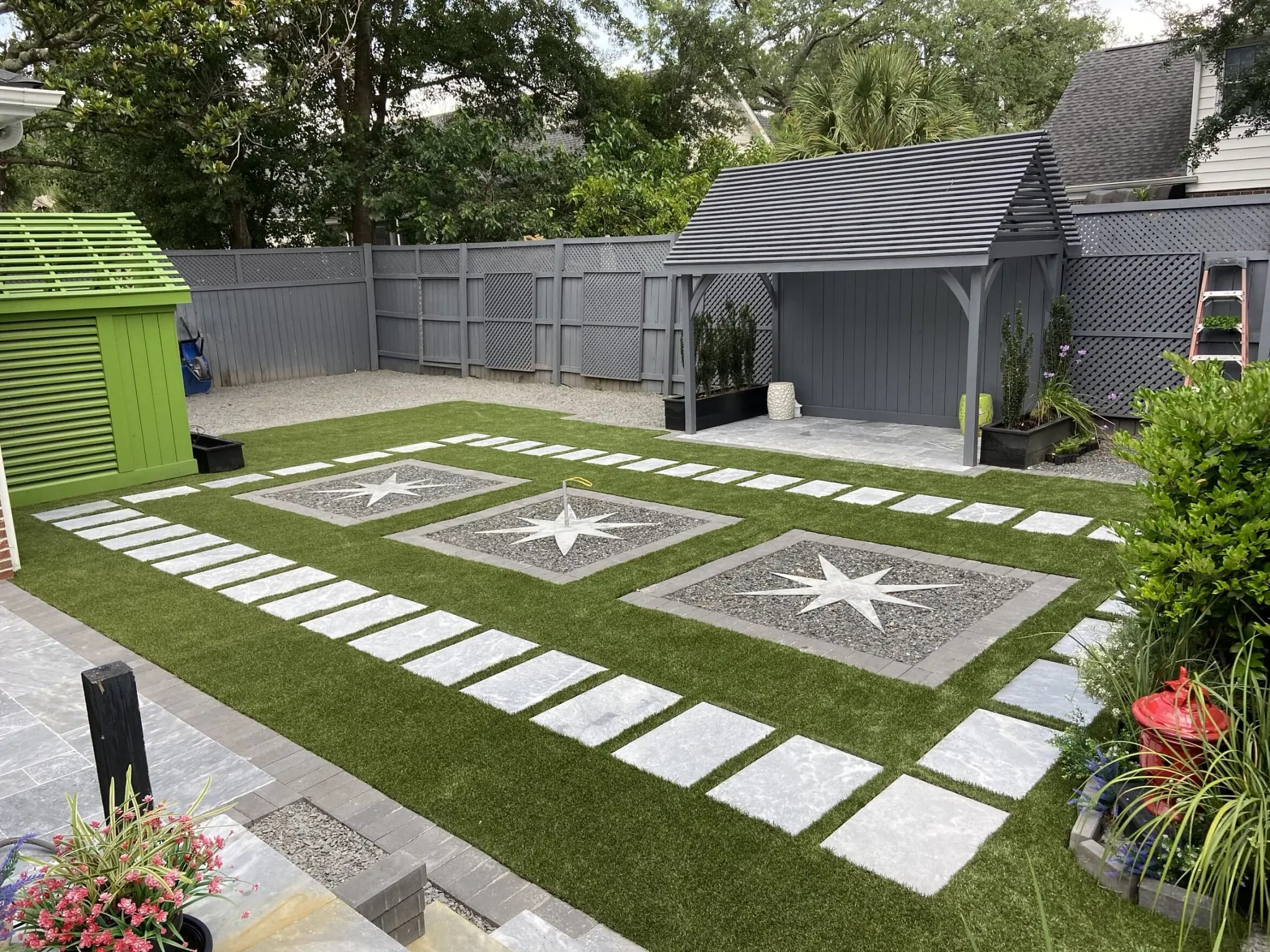 Modern backyard with artificial grass and stone tiles