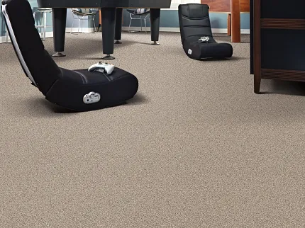 Durable Beige Carpet Flooring in a Cozy Game Room Setting Cozy game room with durable beige carpet flooring, featuring comfortable seating and gaming setup