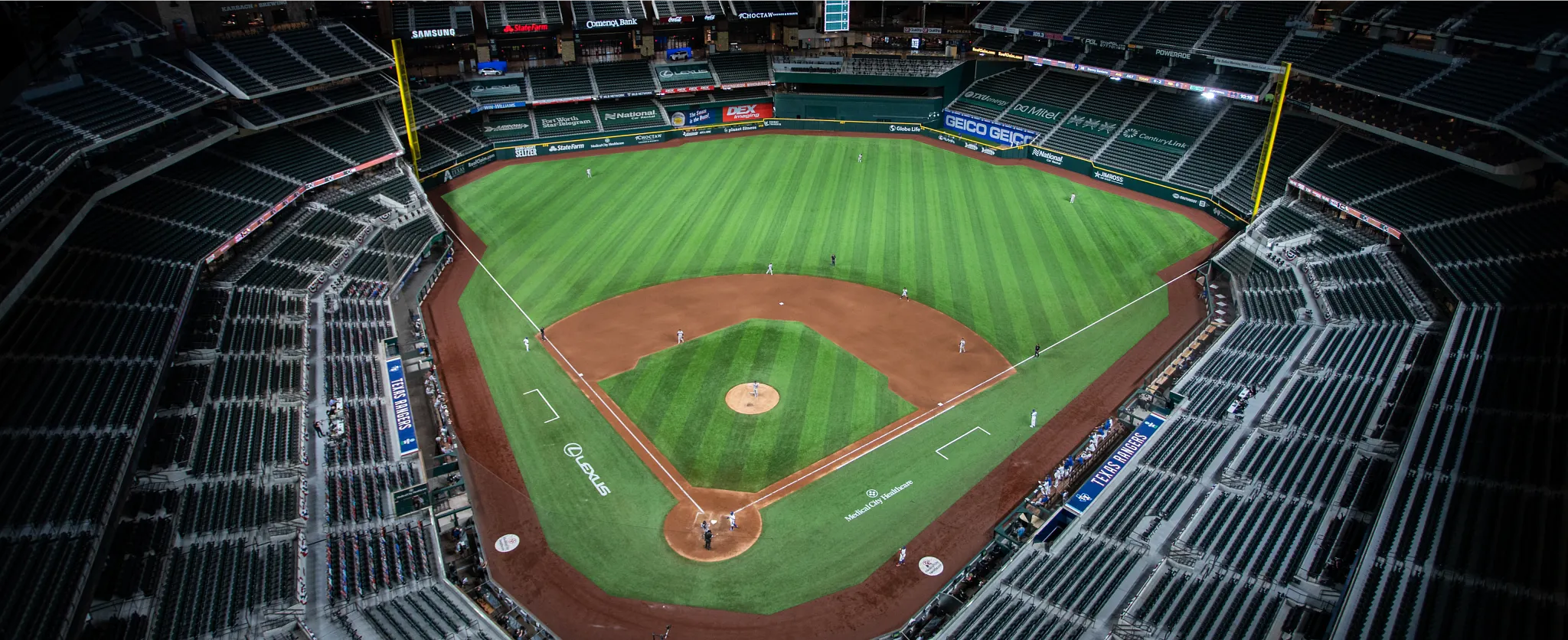 Aerial view of a baseball stadium with artificial turf field