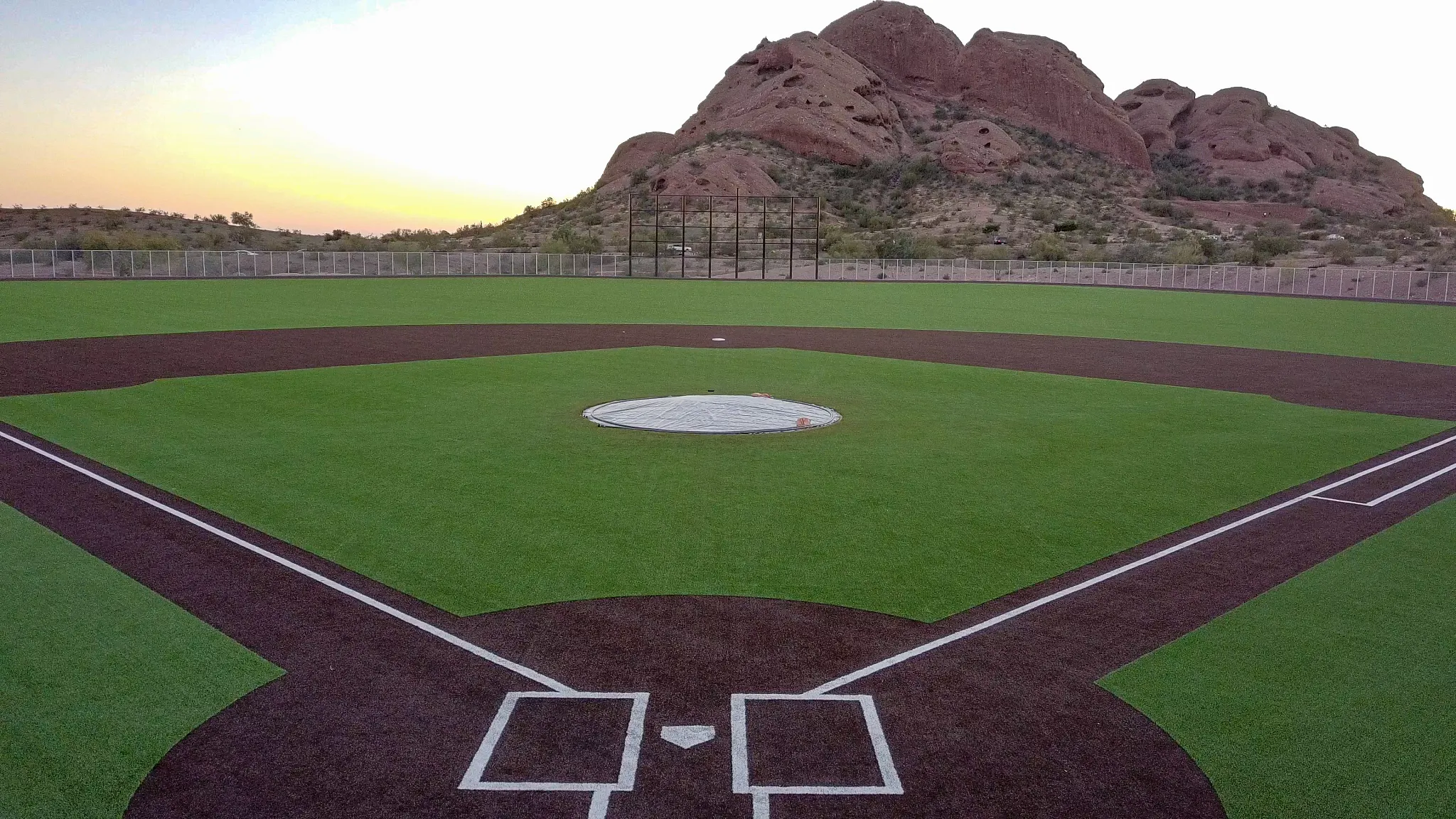 Baseball field with artificial turf and mountain backdrop