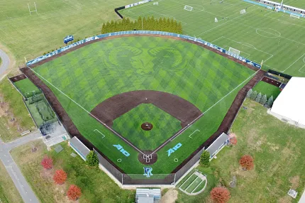 Baseball field with artificial turf and ram logo aerial view. Aerial view of a baseball field with artificial turf featuring a large ram logo in the center