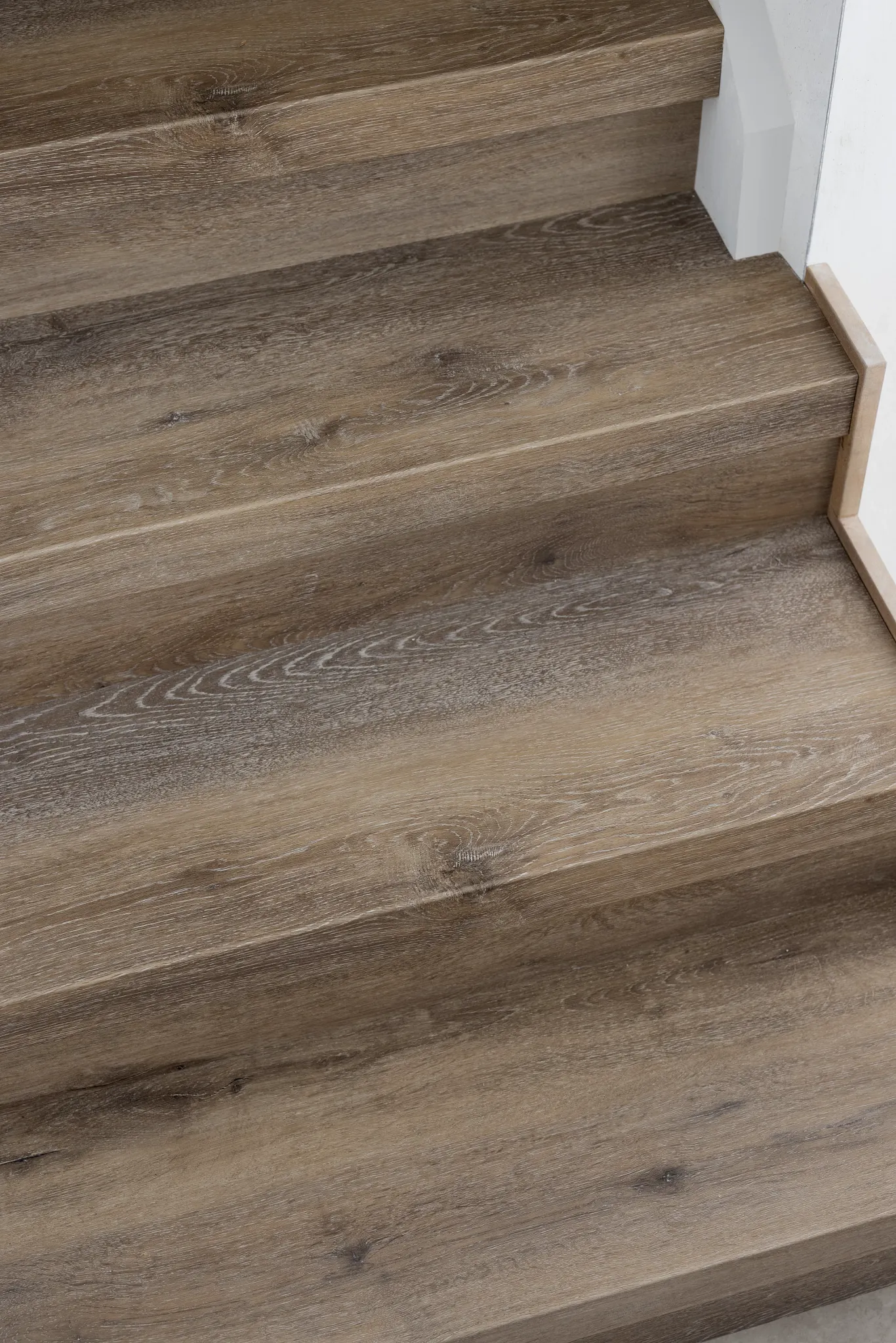 Close-up dark wooden Coretec stairs