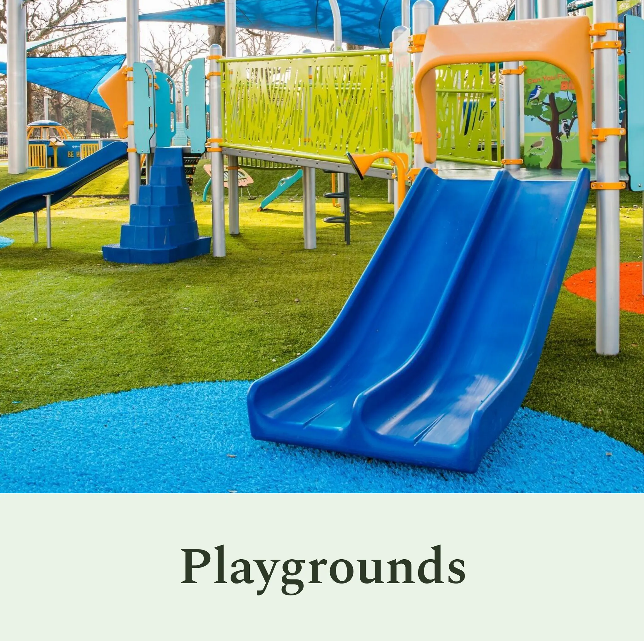 Colorful playground with blue slide and green turf