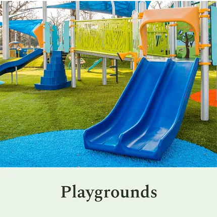 Vibrant playground design for outdoor fun Colorful playground with blue slide and green turf