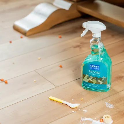 Coretec Residential WPC Flooring - Durable and Easy to Clean 48x7 inch Vinyl Planks Coretec Residential WPC flooring with cleaning spray and scattered food debris