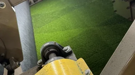 Manufacturing process of synthetic grass flooring Green artificial turf production in factory setting