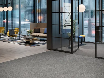 Contemporary Office with Gray Commercial Carpet Tile Flooring Modern office space with large glass windows, featuring gray commercial carpet tile flooring and contemporary furniture