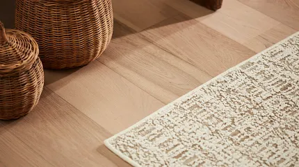 area rug on hardwood floor Area rug on a hardwood floor with baskets stacked around