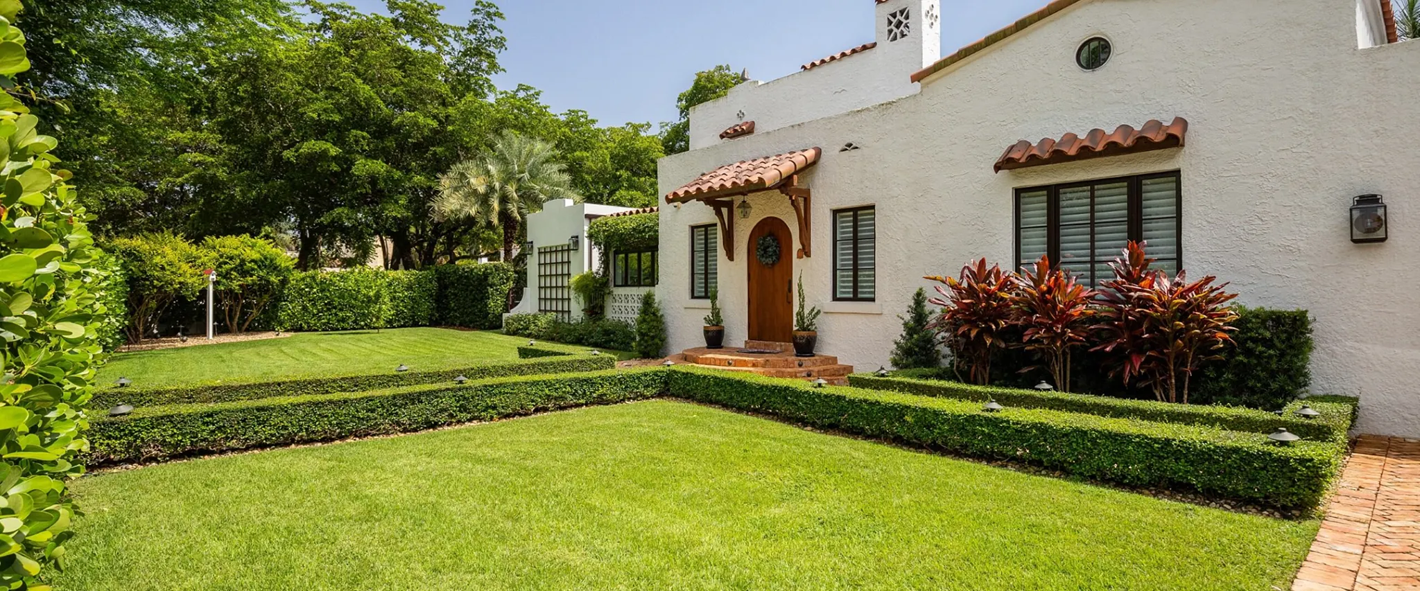 Spanish-style house with lush green garden
