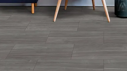 Coretec Residential WPC Luxury Vinyl Tile Flooring in Modern Living Room - 24.02x12.01 inch Modern living room with Coretec Residential WPC luxury vinyl tile flooring in a wood look, featuring a gray armchair with a yellow pillow, abstract wall art, and a navy cabinet, 24.02x12.01 inch dimensions