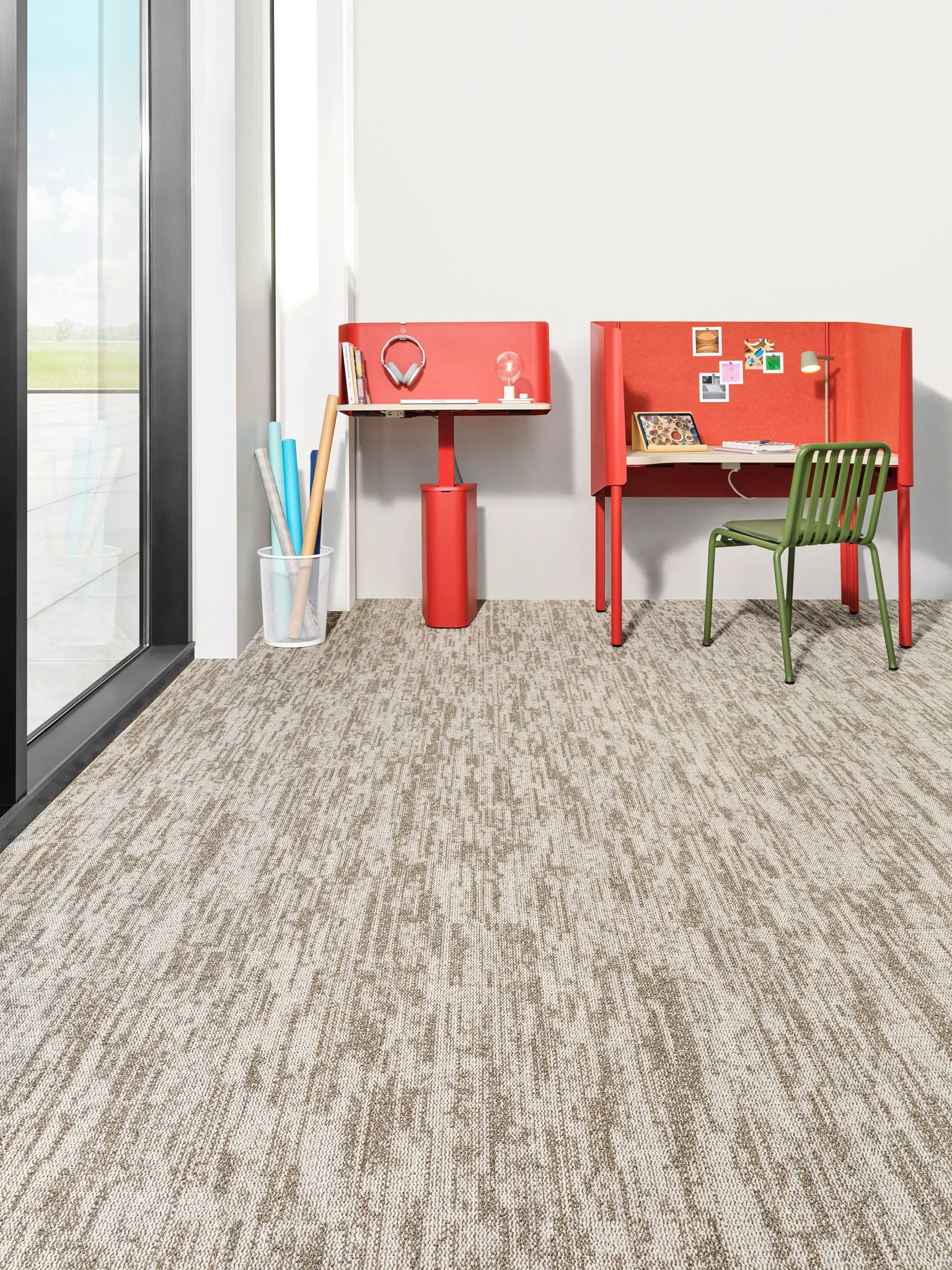 Carpet tile flooring in an education facility with red desks and green chair