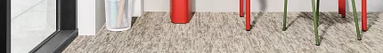 Durable 9x36 inch carpet tiles for educational spaces Carpet tile flooring in an education facility with red desks and green chair