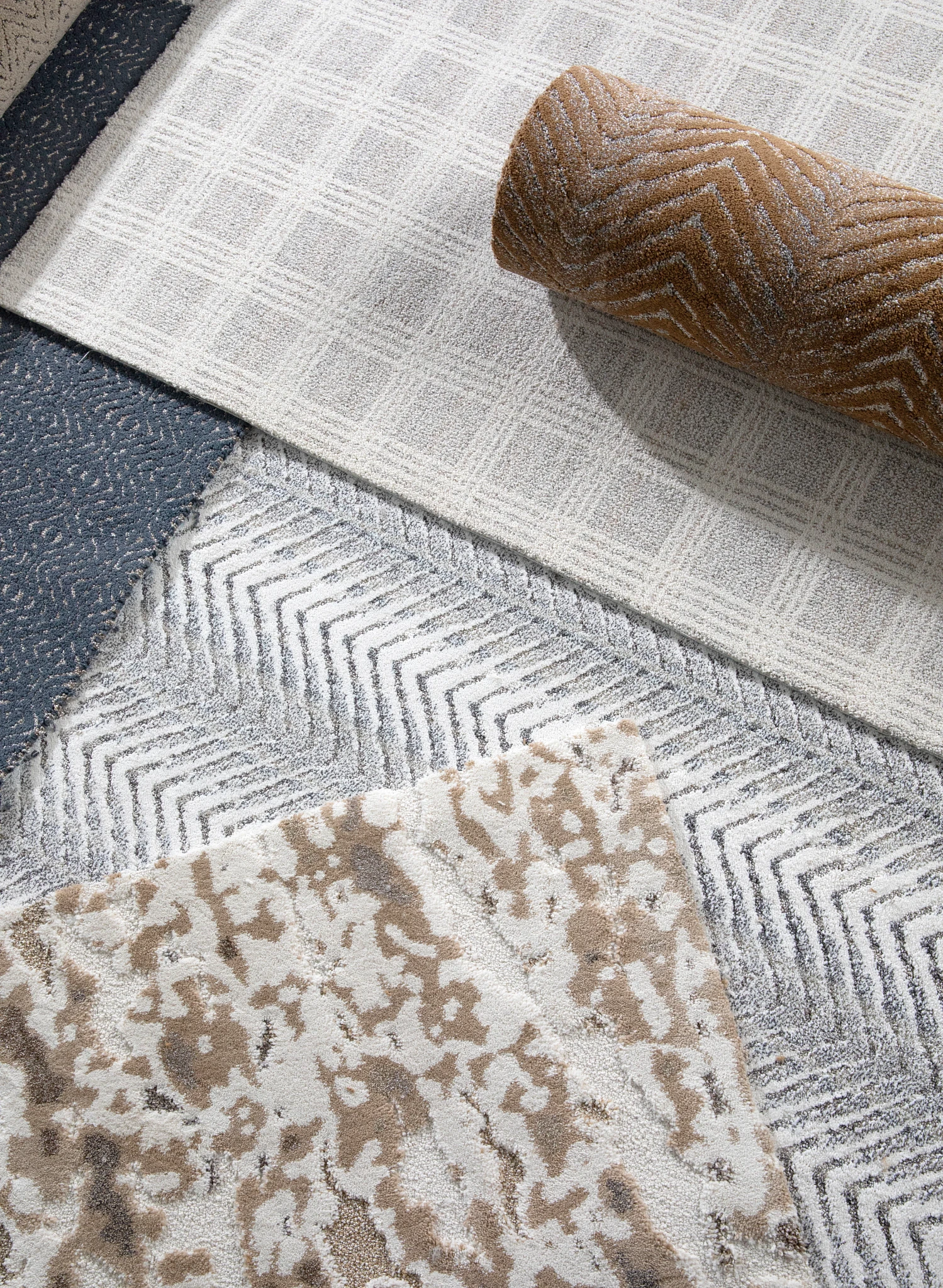 Close-up view of various carpet swatches featuring patterns in blue