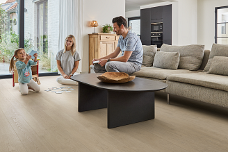 A family in a cozy living room with COREtec vinyl flooring.