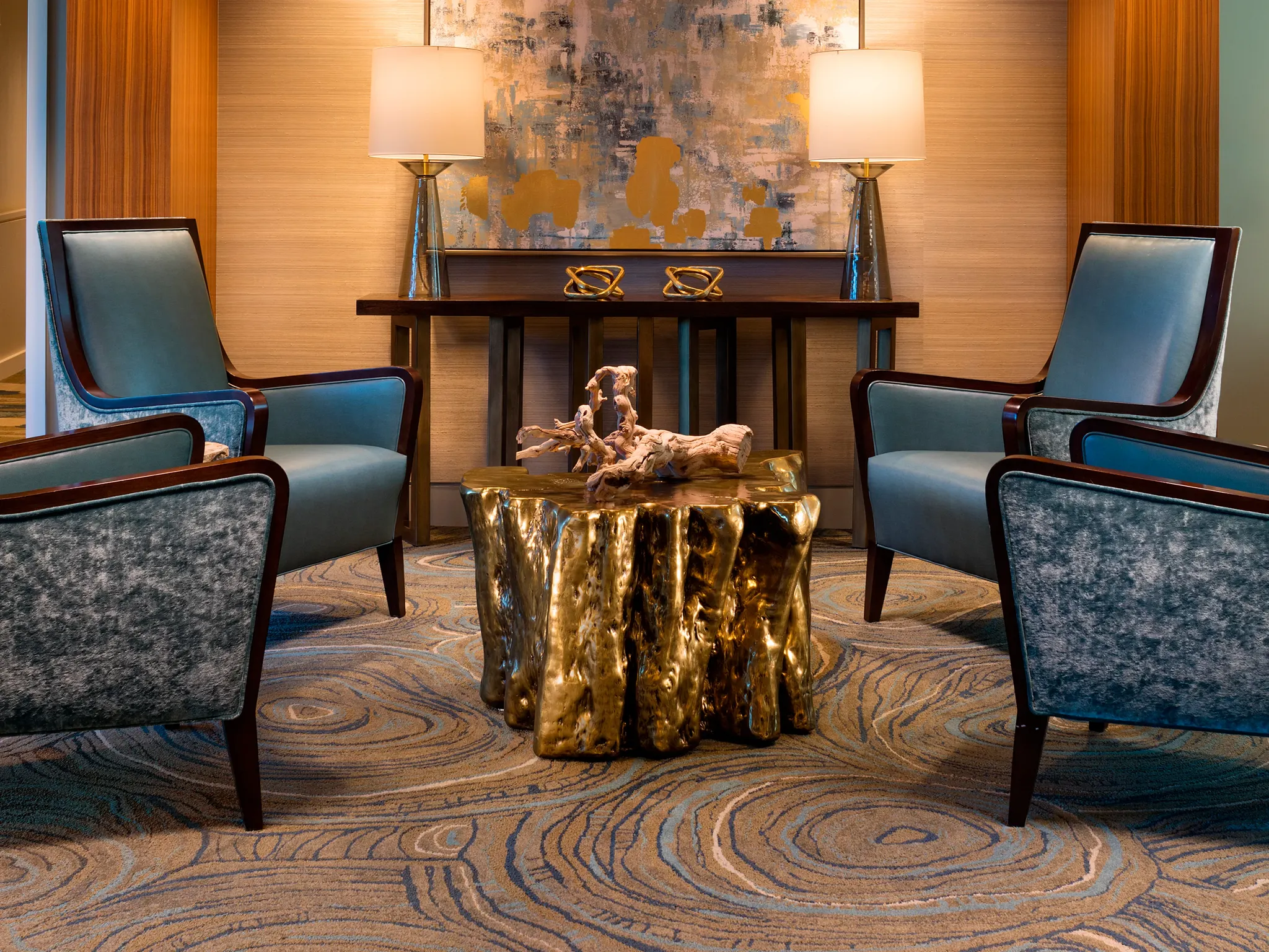 Elegant senior living room with modern chandelier, abstract art, and plush seating on swirling pattern commercial carpet tile