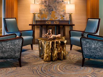 Senior Living Room with Modern Decor and Commercial Carpet Tile Elegant senior living room with modern chandelier, abstract art, and plush seating on swirling pattern commercial carpet tile