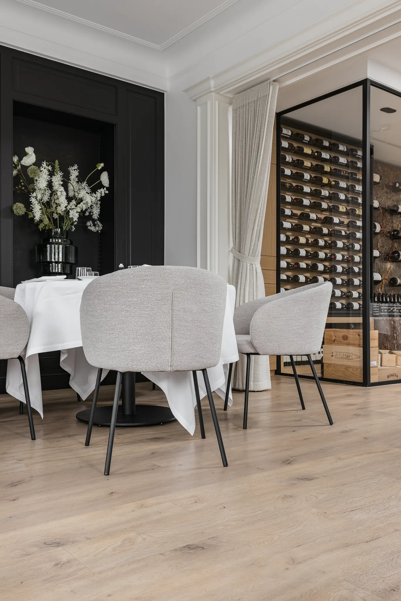 Modern dining room with luxury vinyl plank flooring and wine display