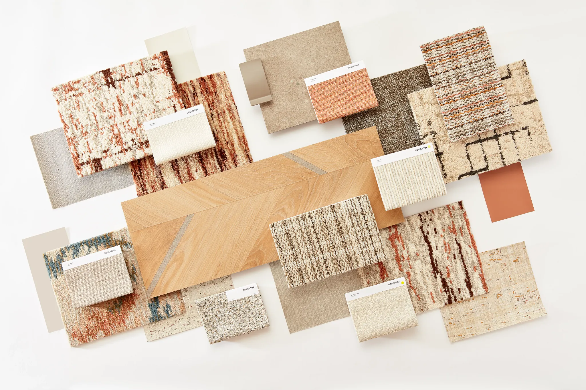 Assorted flooring swatches including commercial carpet tiles and hardwood in various colors and textures
