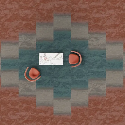 Modern Office Space with Geometric Patterned Commercial Carpet Tiles in Rust, Teal, and Gray Overhead view of a modern office space featuring a geometric pattern of commercial carpet tiles in shades of rust, teal, and gray with two orange chairs and a white marble table