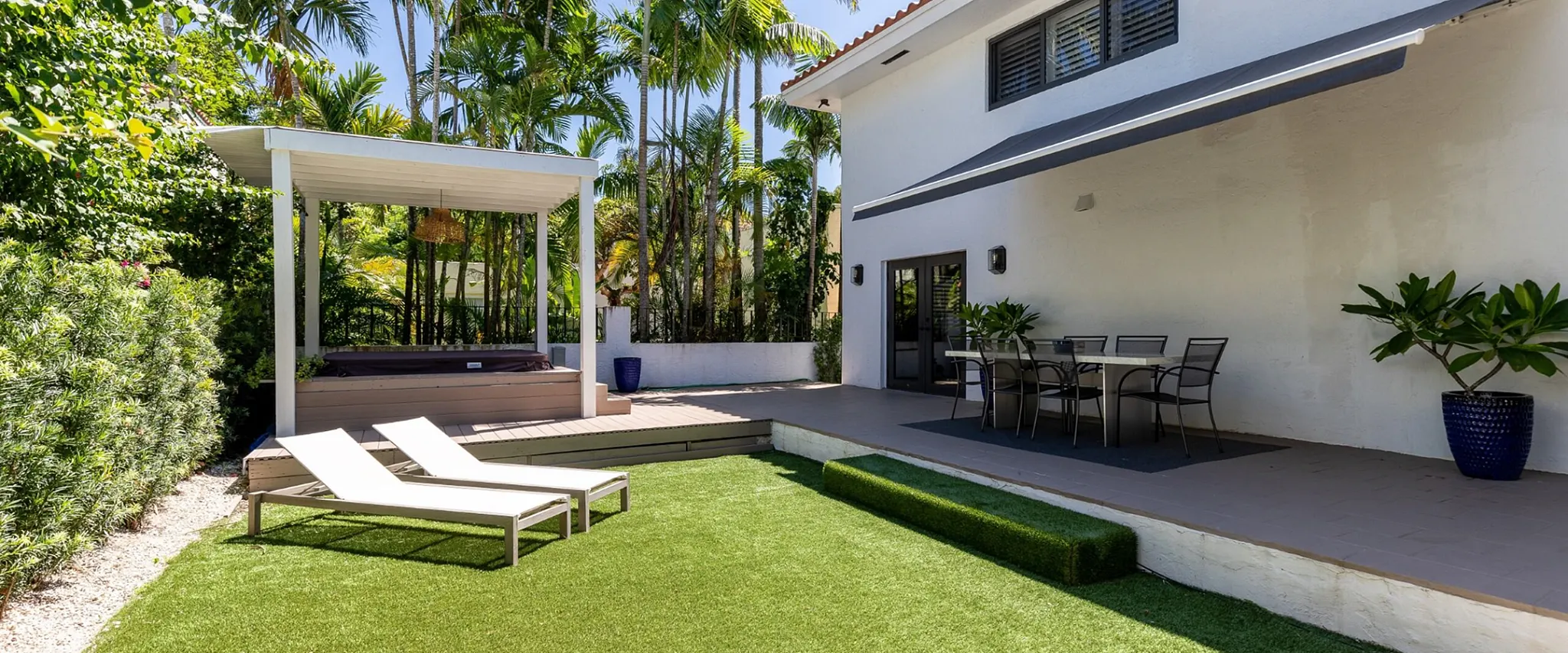 Outdoor patio with artificial grass and modern furniture