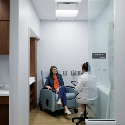 Healthcare Facility Consultation Room with Light Wood Flooring Healthcare Facility with light wood flooring and two people in a consultation room